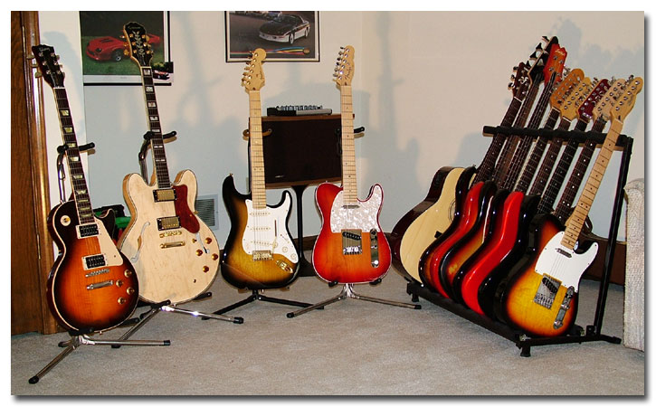 Left to right: Custom Gibson Les Paul, Epiphone Sheraton II, Fender 50th Anniversary American Deluxe Strat, Fender American Deluxe Tele, Yamaha FG-411 CE Acoustic, Peavey Millennium BXP Bass, Custom Sigma Bass, Fender Jazzmaster, Custom Tokai Strat, Schecter Strat, Custom Fender Fat Strat, Fender Telecaster