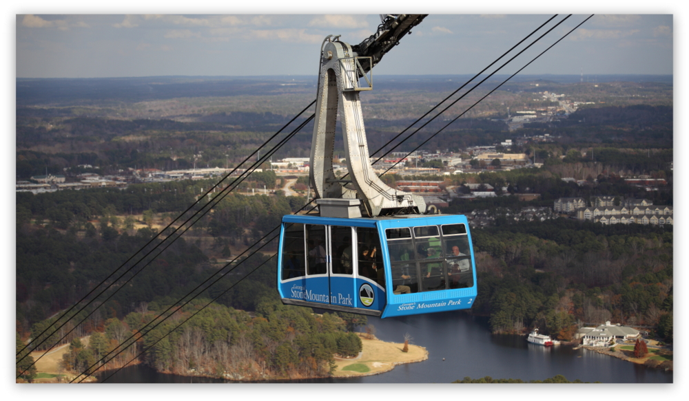 Stone Mountain Park, Dec 03, 2012 - The blue Summit Skyride/Skylift car descends from the top of Stone Mountain